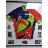 A CYCLING VEST SIGNED BY SEAN YATES, MOUNTED IN A LARGE GLAZED FRAME, 86CM BY 81CM