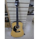 A FALCON LEFT HANDED ACOUSTIC GUITAR, MODEL NO. LFG100N, WITH METAL STAND