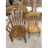 AN OAK WINDSOR CHAIR WITH CARVED FLOWER MOTIF TO THE TOP, TOGETHER WITH A MODERN PINE DINING CHAIR