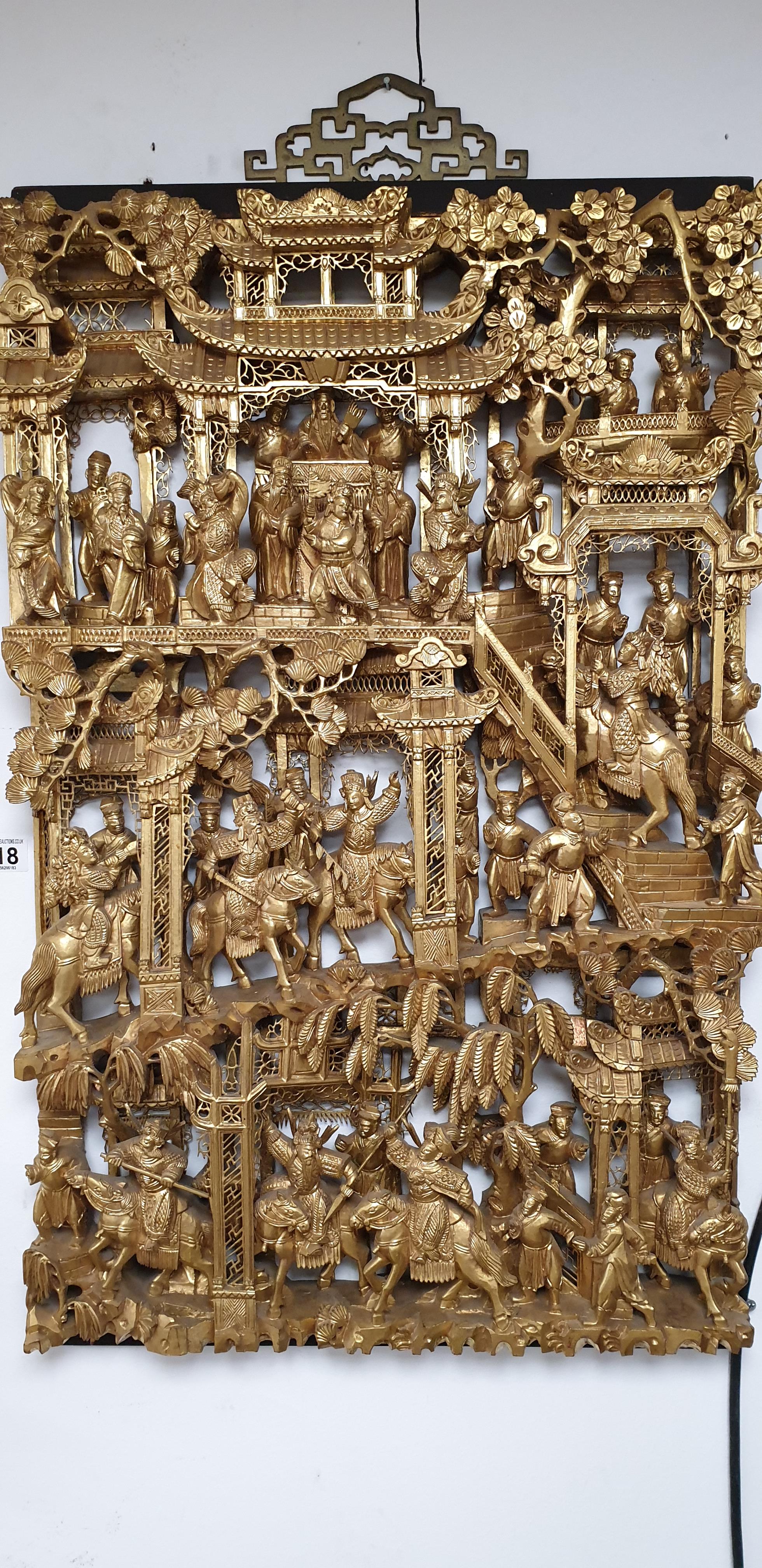 A CHINESE HEAVILY CARVED WOODEN WALL PLAQUE DEPICTING A SCENE WITH AN EMPORER WITH HIS PEOPLE, GILT,