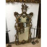 A LARGE ORNATELY 19TH CENTURY DECORATED GILT WOOD FRAMED WALL MIRROR, 172CM BY 80CM