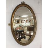 LARGE OVAL GILDED BEVELLED MIRROR 83 X 58 CMS