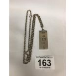 A SILVER INGOT ON SILVER CHAIN, HALLMARKED LONDON 1977 BY P & R BUSHELL, 45.3G