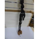AN UNUSUAL CARVED WOODEN TANZANIAN MAKONDE FIGURE OF A WITCH DOCTOR, CARVED IN EBONY, 90CM HIGH