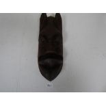 A CARVED WOODEN TRIBAL MASK FROM BOTSWANA, 44CM LONG