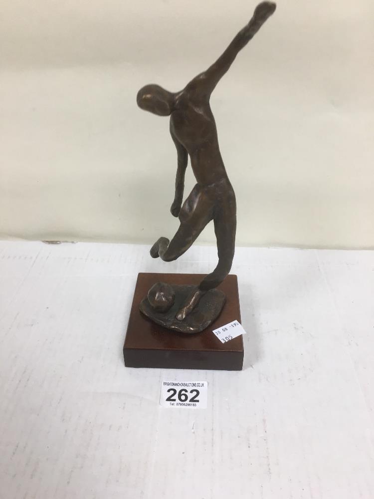 A BRONZE FIGURE OF A FOOTBALLER ABOUT TO STRIKE THE BALL, INDISTINGCTLY SIGNED TO THE BASE, 27.5CM