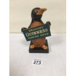 AN EARLY RUBBER GUINNESS ADVERTISING FIGURE OF A PENGUIN "DRAUGHT GUINNESS SERVED HERE", 18CM HIGH