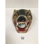 A CARVED TRIBAL WOODEN WALL MASK IN THE FORM OF A LION OR LEOPARD, 25CM BY 21CM