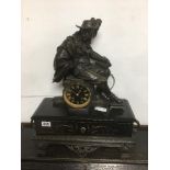 METAL AND BLACK SLATE MANTLE CLOCK WITH A STATUE OF D'ARTANGAN FRENCH MOVEMENT FROM NANTES 56 CMS