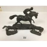 A BRONZED FIGURE OF A JOCKEY RIDING A HORSE TOGETHER WITH TWO SMALLER FIGURES OF HORSES, ALL