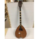 A VINTAGE MANDOLIN WITH MOTHER OF PEARL DETAILING THROUGHOUT