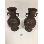 A PAIR OF LATE 19TH CENTURY JAPANESE BRONZE VASES OF BALUSTER FORM WITH TWIN HANDLE FINIALS,