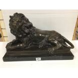 AN EXCEPTIONALLY LARGE BRONZE FIGURE OF A LION LYING DOWN, RAISED UPON A MARBLE BASE, UNKNOWN MAKER,