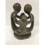 A ABSTRACT SOAPSTONE SCULPTURE OF FOUR PEOPLE IN A CIRCLE, 22.5CM HIGH