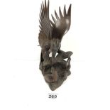 A VINTAGE CARVED WOODEN WITH FIGURE GROUP DEPICTING A LARGE BIRD ABOVE TWO SMALLER BIRDS WITH