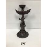 AN UNUSUAL ANTIQUE BRONZE CANDLESTICK DEPICTING A CHERUB RIDING A DOLPHIN LIKE CREATURE WHICH IS