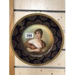 A ROSENTHAL PORCELAIN PLATE WITH PAINTED SCENE TO FRONT OF A FEMALE ARTIST, 25.5CM DIAMETER
