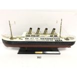A MODERN WOODEN MODEL OF THE TITANIC, RAISED UPON WOODEN BASE, 50.5CM WIDE