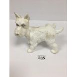 A WHITE PAINTED CAST METAL FIGURE OF A WESTIE DOG, 19CM WIDE