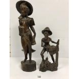 TWO INDONESIAN CARVED HARDWOOD FIGURES, ONE OF A LADY, THE OTHER A FISHERMAN, ONE MARKED TO BASE "
