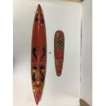 TWO DECORATIVE WALL ART TRIBAL MASKS PAINTED RED YELLOW AND BLACK, THE LARGEST BEING 102CM TALL