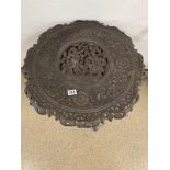 A HEAVILY WOODEN CARVED MIDDLE EASTERN SIDE TABLE 62CMS DIAMETER