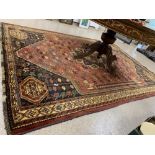 A LARGE DEEP PILE WOOL RUG IN ORANGE RED AND BLACK WITH LEAF AND HORSE DESIGN, 286CM BY 203CM
