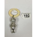 A SILVER PLATE CHILDS RATTLE DEPICTING A BOY DRESSED AS A SOLDIER, WITH TEETHING RING, MARKED TO