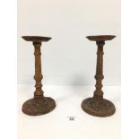 A PAIR OF SMALL HEAVY CAST IRON SPIT CANDLESTICKS, 29.5CM HIGH