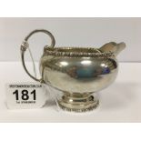 A SILVER CREAM JUG OF CIRCULAR FORM, RAISED UPON PEDESTAL BASE WITH BEADED BORDER, HALLMARKED