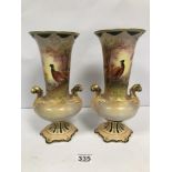 A PAIR OF EARLY 20TH CENTURY CROWN DEVON CERAMIC URN SHAPED VASES WITH HAND PAINTED SCENES OF