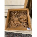 AN UNUSUAL SMALL WOODEN TABLE WITH HEAVILY CARVED EASTERN FARM SCENE TO THE TOP, 35CM HIGH