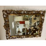 AN ORNATE GILDED MIRROR 92 X 69CMS A/F