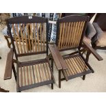 A PAIR OF TEAK FOLDING GARDEN CHAIRS