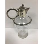 A LATE VICTORIAN SILVER MOUNTED GLASS CLARET JUG, THE LID MOUNTED WITH AN EGYPTIAN SPHINX FINIAL,