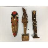 THREE ETHNOGRAPHIC ITEMS INCLUDING TWO CARVED WOODEN STATUES AND A DECORATIVE TRIBAL MASK