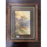 A SIGNED COUNTRY ROAD WATERCOLOUR GOUACHE SCENE IN A WOODEN GLAZED FRAME AND WITH A WOODEN MOUNT