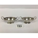 A PAIR OF VICTORIAN SILVER TWIN HANDLED SALTS OF OVAL FORM, HALLMARKS RUBBED, COMBINED WEIGHT 55.1G