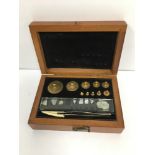 AN EARLY 20TH CENTURY SET OF SCALE WEIGHTS, RANGING FROM 100MG TO 100G, ALL FITTED IN ORIGINAL