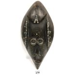 AN AFRICAN CARVED WOODEN TRIBAL MASK WITH INLAID METAL DETAILING, 46.5CM LONG