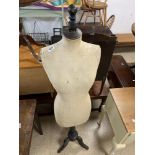 A STOCKMAN MANNEQUIN TAILOR'S DUMMY ON A WOODEN PEDESTAL BASE