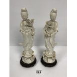A PAIR OF ORIENTAL BLANC DE CHINE FIGURES OF LADIES, RAISED UPON WOODEN BASES, 33CM HIGH (1 AF)