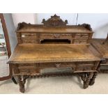 A CONTINENTAL CARVED OAK WRITING DESK ON BARLEY TWIST LEGS WITH KEYS, 127CM WIDE