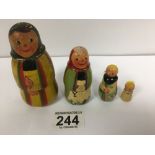 A VINTAGE PAINTED WOODEN RUSSIAN DOLL, FOUR SIZES, LARGEST 10.5CM HIGH