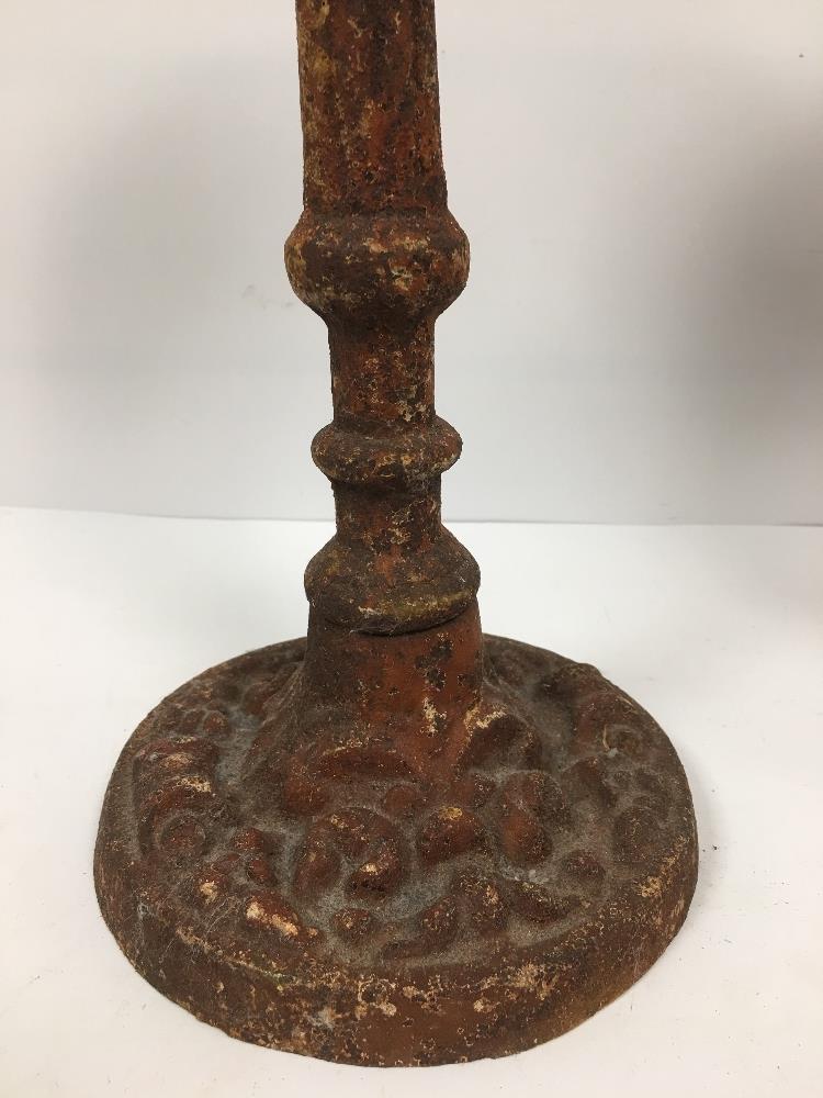 A PAIR OF SMALL HEAVY CAST IRON SPIT CANDLESTICKS, 29CM HIGH - Image 4 of 4