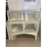 A VINTAGE GLAZED AND CREAM PAINTED DISPLAY CABINET WITH TWO DOORS UNDER AND KEY AND SLIDING DOORS TO