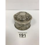 A VICTORIAN SILVER CIRCULAR LIDDED BOX WITH EMBOSSED DECORATION THROUGHOUT, HALLMARKED LONDON 1893