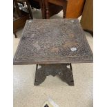 AN EARLY HEAVILY CARVED INDIAN TABLE, 59CM WIDE