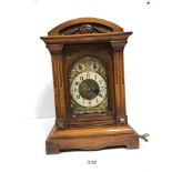 A 19TH CENTURY WALNUT CASED MANTLE CLOCK, THE DIAL WITH ARABIC NUMERALS DENOTING HOURS, ABOVE