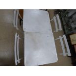 A PAIR OF WHITE METAL FOLDING GARDEN TABLE AND FOUR CHAIRS